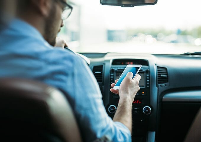 Distracted driver looking at phone, DMS warning signal