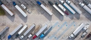 An aerial view image of a fleet of trucks on a parking lot